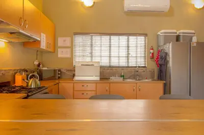 a kitchen with a refrigerator and a counter top at Kudus Crest Bush Retreat in Marloth Park