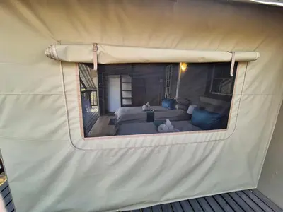 a view of a living room in a tent at Kudus Crest Bush Retreat in Marloth Park
