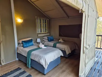 a bedroom with two beds in a tent at Kudus Crest Bush Retreat in Marloth Park