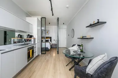 a kitchen and living room with a table and chairs at iNqaba @Ellipse Waterfall in Midrand