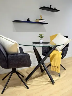 a glass table with two chairs and a plant on it at iNqaba @Ellipse Waterfall in Midrand