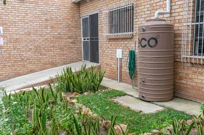 an oc compressor sitting on the side of a brick building at Ingwe House in Marloth Park