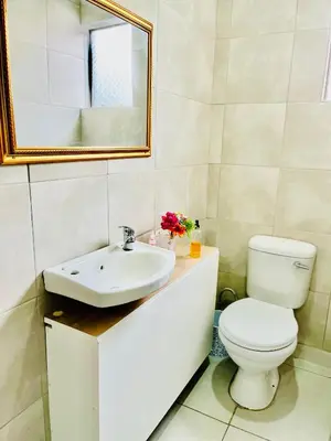 a bathroom with a toilet and a sink at Executive Galaxy Guest House Nkowankowa Extension 2 in Tzaneen