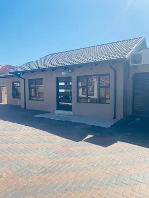 a building with a door and a garage at Executive Galaxy Guest House Nkowankowa Extension 2 in Tzaneen