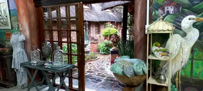 a room with a bunch of vases on a wall at Duck and Dine in Pretoria