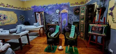 a room with a room with paintings on the walls at Duck and Dine in Pretoria