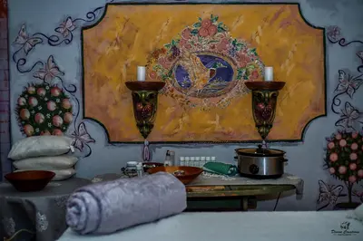 a table with two candles and a painting on the wall at Duck and Dine in Pretoria