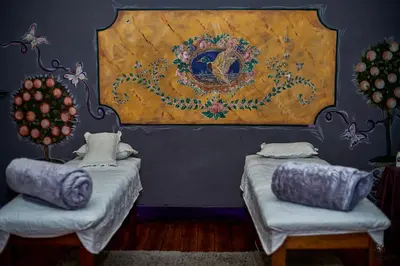 a room with two beds and a painting on the wall at Duck and Dine in Pretoria