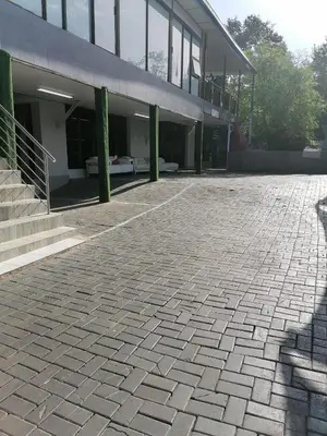 an empty parking lot in front of a building at Tshilidzi Guest House in Pretoria
