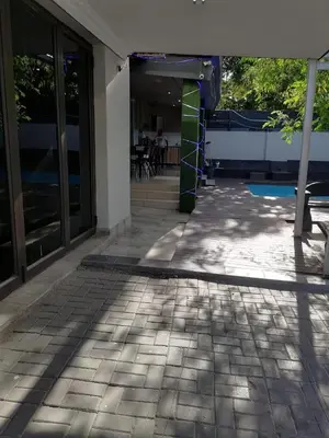 a patio of a building with a table and chairs at Tshilidzi Guest House in Pretoria