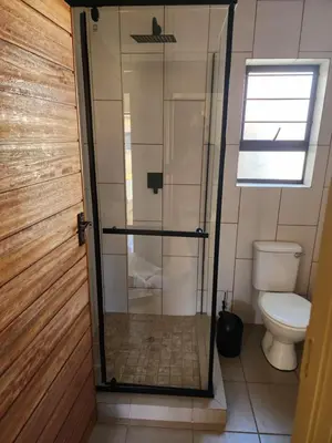 a shower in a bathroom with a toilet at Lloyds - 6 in Ermelo