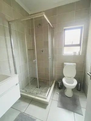 a bathroom with a shower and a toilet at Joy Apartment@The Blyde in Pretoria