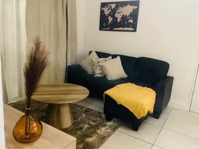a living room with a couch and a table at Joy Apartment@The Blyde in Pretoria