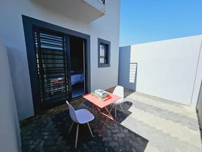 a small red table and a chair in a room at Quantum Heights - Studio Apartment - 2 nights minimum booking in Fourways