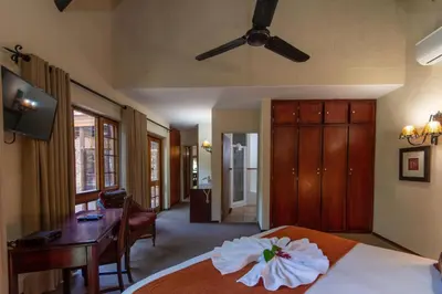 a bedroom with a bed with a white flower on it at Kruger Park Lodge Unit No. 265 in Hazyview