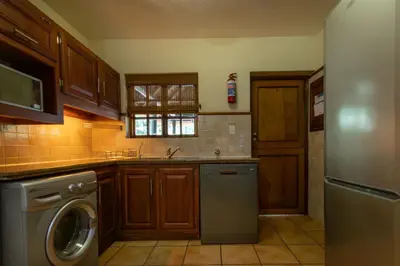 a kitchen with a dishwasher and a washer in it at Kruger Park Lodge Unit No. 265 in Hazyview