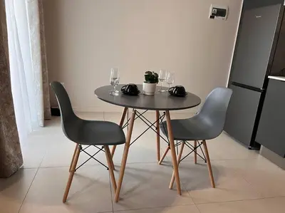 a table with two chairs and wine glasses on it at 93 on new unique and classy in Midrand
