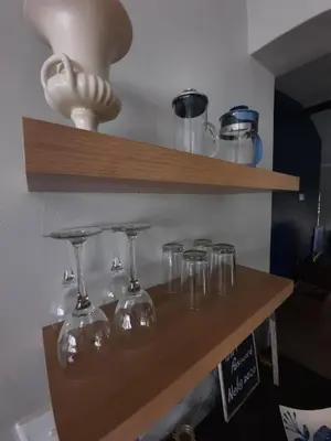 a shelf with wine glasses sitting on it at Nel's Cottage, a private and peaceful cottage in Benoni