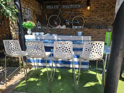 a table with four chairs and a bike on the wall at Ocean Vibe in Pretoria