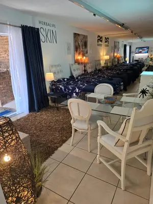 a room with a long table with white chairs at Ocean Vibe in Pretoria
