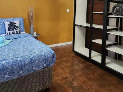 a bedroom with a bed and a book shelf at Residential Inn in Pretoria