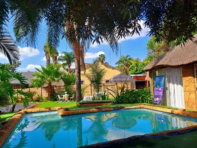 a swimming pool in front of a house at Residential Inn in Pretoria