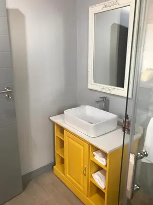 a bathroom with a sink and a mirror at Blue Lotus Guest House Pta East-Solar power in Pretoria