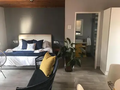 a bedroom with a bed with blue and yellow pillows at Blue Lotus Guest House Pta East-Solar power in Pretoria