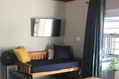 a room with a blue bench and a window at Blue Lotus Guest House Pta East-Solar power in Pretoria
