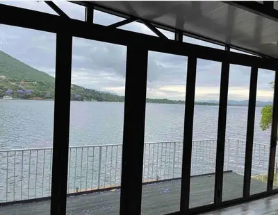 a view of a large body of water from a window at Sun Room (Studio) on the edge of the Harties dam. in Hartbeespoort