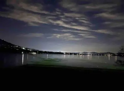 a view of a lake at night at Sun Room (Studio) on the edge of the Harties dam. in Hartbeespoort
