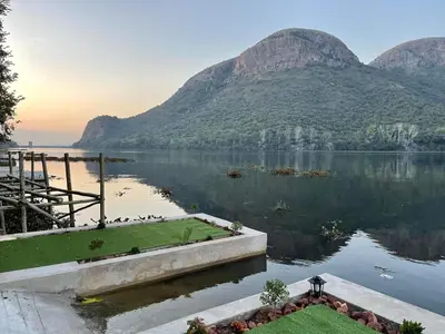 a view of a lake with mountains in the background at Sun Room (Studio) on the edge of the Harties dam. in Hartbeespoort