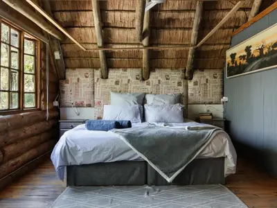 a bedroom with a large bed in a room at Stone cottage in Haarties in Kalkheuvel