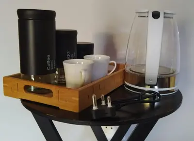 a wooden tray with cups and a blender on a table at Quintax Guest House in Pretoria