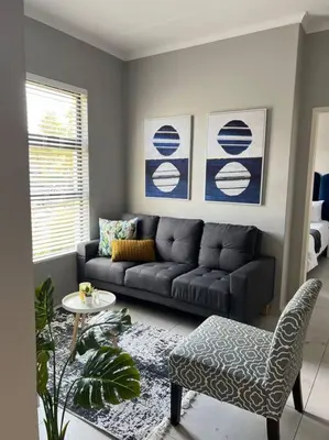 a living room with a couch and a table at Blue Lilly - 50 on Lever Unit 19 in Midrand