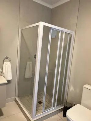 a shower stall in a bathroom with a toilet at Blue Lilly - 50 on Lever Unit 19 in Midrand